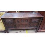 A 20th century oak sideboard with a carved front,