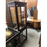 A 20th century oak display cabinet with a pair of leaded glazed doors and glazed sides