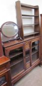 An Edwardian rosewood display cabinet with a rectangular top above glazed doors on cabriole legs