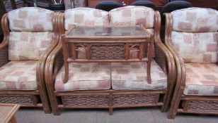 A wicker conservatory suite comprising a two seater settee,