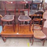 A set of four bedroom chairs with a carved back and caned seats together with a walnut coffee table