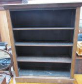 A 20th century oak bookcase with a moulded cornice above three shelves on a plinth