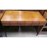 A mid 20th century oak desk with a rectangular top above six drawers on black metal square section