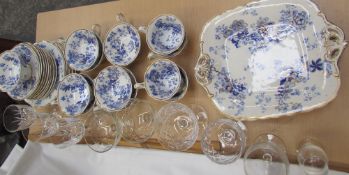 A blue and white pottery part tea set together with drinking glasses