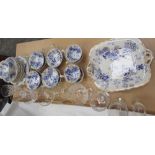 A blue and white pottery part tea set together with drinking glasses