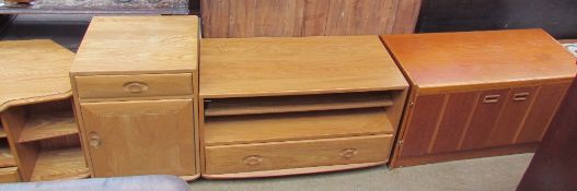 An Ercol television stand together with a matching side cabinet, a low teak cabinet,