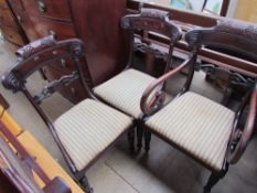 A set of three Regency mahogany dining chairs, with a carved bar back,