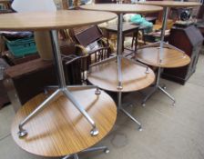 A set of six cafe tables with circular melamine tops on chrome columns and a four splayed legs