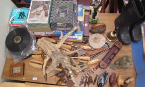 A spelter figure of a seated lady together with jigsaw puzzles, shoe trees, model ducks,