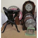 An American walnut mantle clock together with two mid 20th century mantle clocks, carved figures,