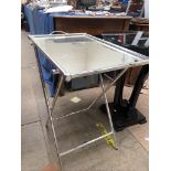 A modern occasional table of circular form with a glass top and a shaped base together with a