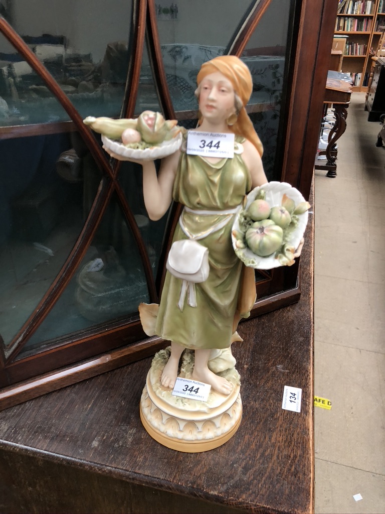 A Royal Dux figure of a fruit seller,