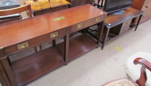 A mahogany and brass bound side table with a rectangular top above two drawers on square legs