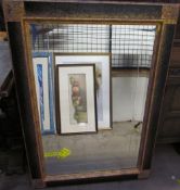 A large rectangular wall mirror with red and gilt decoration