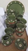 A modern Nantgarw pottery part tea set decorated in green with cream circular decoration,