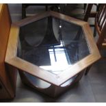 A mid 20th century teak and glass coffee table of hexagonal form with shaped legs on a plinth base