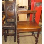 An oak back stool with a winged lion carved back and a leather upholstered seat on turned legs