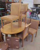 A Skovby oak dining suite comprising an oval extending dining table and six chairs