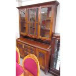 An Edwardian oak kitchen dresser with a moulded cornice above a pair of glazed doors and a leaded