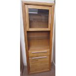 A modern oak side cabinet with a glazed door to the top,
