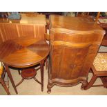 A reproduction mahogany occasional table of circular form,
