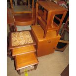 A mid 20th century teak nest of tables with a tiled top,