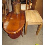 A reproduction yew wood coffee table of oval form together with an oak nest of two tables and a