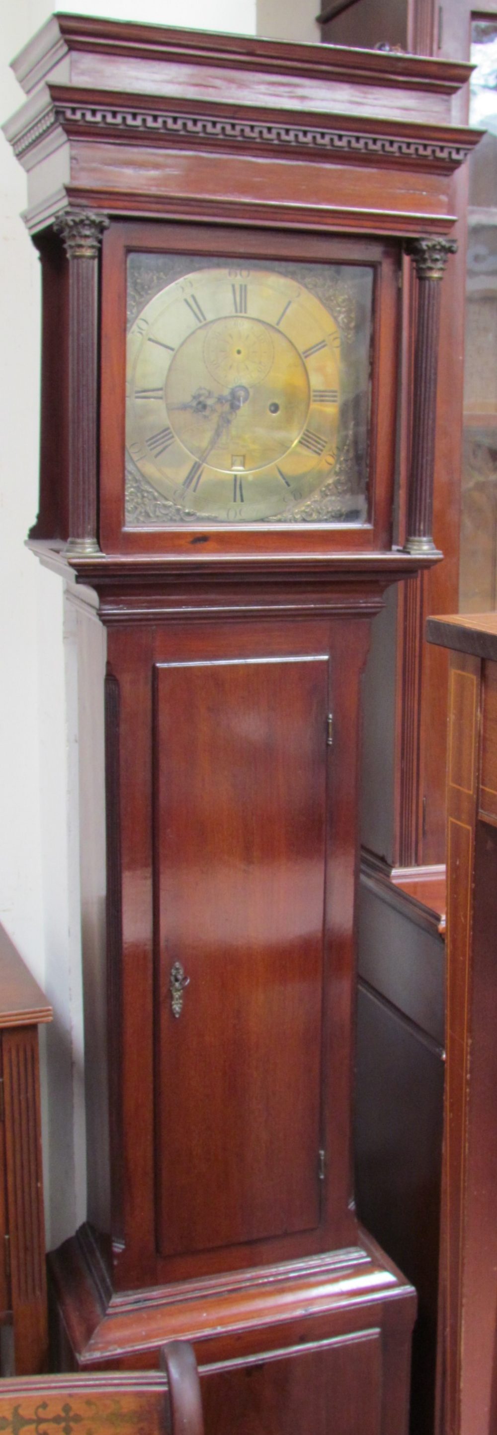 A 19th century mahogany longcase clock, with a stepped hood above a long trunk door,