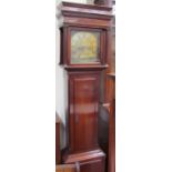 A 19th century mahogany longcase clock, with a stepped hood above a long trunk door,
