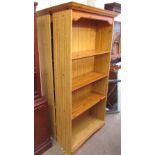 A matched pair of modern pine effect bookcases