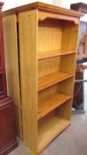 A matched pair of modern pine effect bookcases