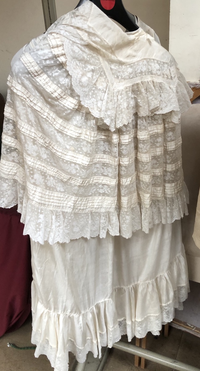 A collection of Edwardian lace christening gowns and a jacket