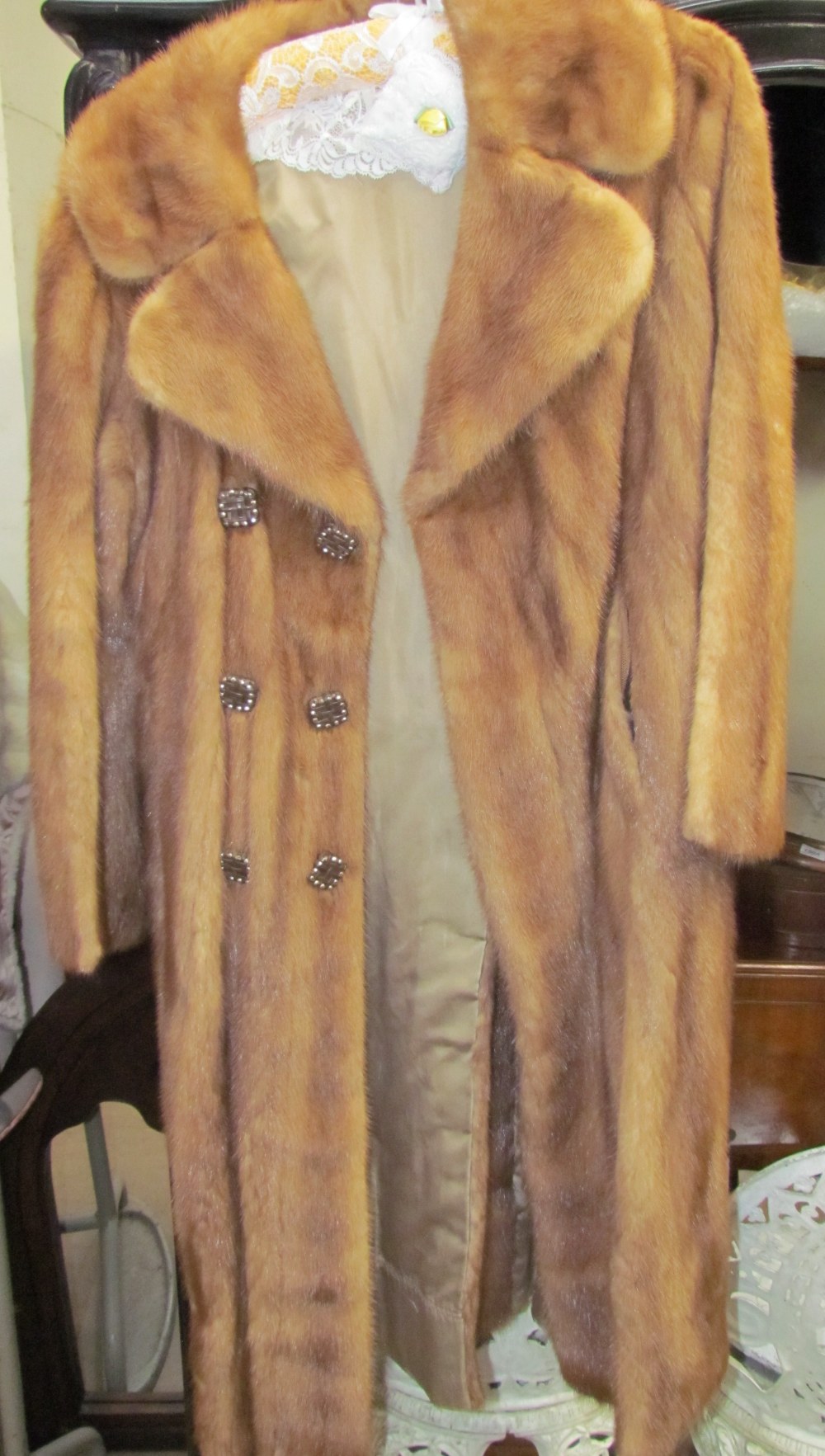 A full length fur coat with marcasite set lattice buttons