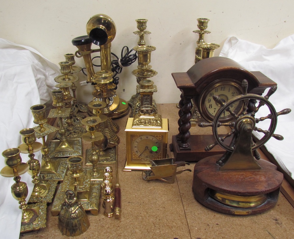 A brass pillar telephone, together with brass candlesticks, brass clock,