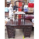 A mahogany pedestal desk with a rectangular top above a central drawer and two pedestals of drawers