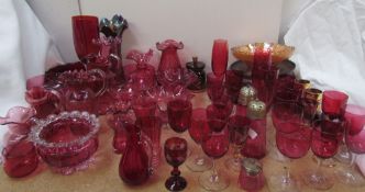 A large quantity of cranberry glass including vases, jugs, wine glasses,