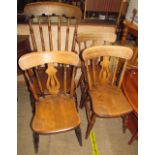 A kitchen spindle back elbow chair together with a set of three kitchen dining chairs
