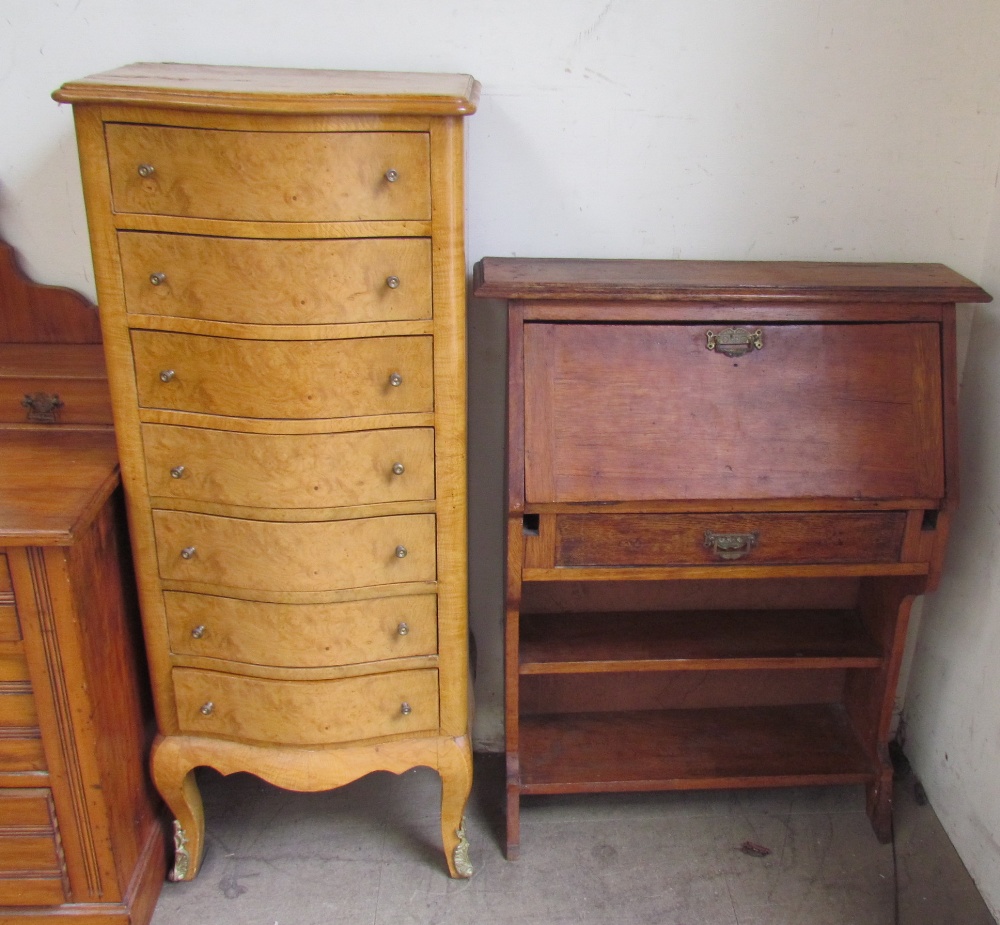 A birds eye maple chest with a serpentine top above seven graduated drawers on cabriole legs and