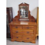 An Edwardian satin walnut dressing table, the rectangular mirror with an architectural pediment,
