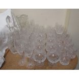 A suite of crystal drinking glasses including champagne glasses, brandy balloons, whisky tumblers,