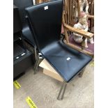 A set of four black leather Italian design dining chairs with brushed stainless steel legs