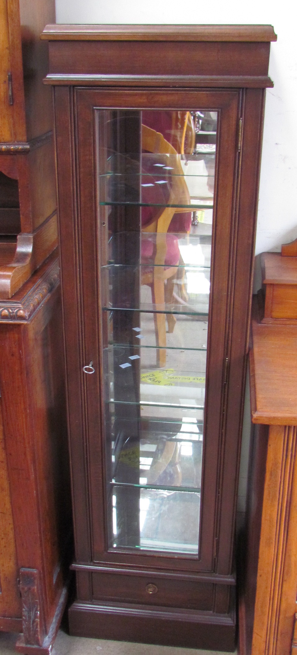 A 20th century mahogany display cabinet with a moulded top above glazed sides and doors with a base