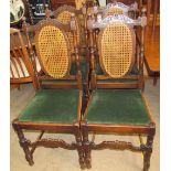 A set of four oak and caned dining chairs with a drop in seat together with an oak bookcase and an