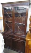 An Edwardian walnut mirrorback sideboard with a rectangular mirror and shelf,