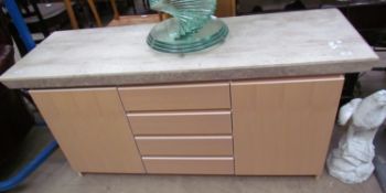 A modern sideboard with a reconstituted marble top,