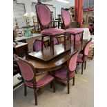 A reproduction mahogany extending dining table and eight chairs