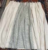 A pair of cream linen with a patterned leading edge curtains, lined and interlined,