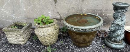 A reconstituted stone bird bath on a twisting tree and fruit column together with two reconstituted