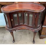 A 20th century mahogany kidney shaped display cabinet,