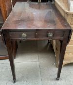 A Victorian mahogany pembroke table the rectangular top with drop flaps above a frieze drawer on